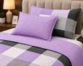 Close-up of lavender patchwork comforter set showing pillow sham and stripe pillow cover